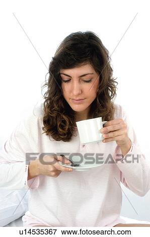 Stock Photo - Woman, Breakfast, Having breakfast, Beauty, Young, Young woman, Brown hair. Fotosearch