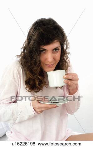 Stock Photo - Woman, Breakfast, Having breakfast, Beauty, Young, Young woman, Brown hair. Fotosearch