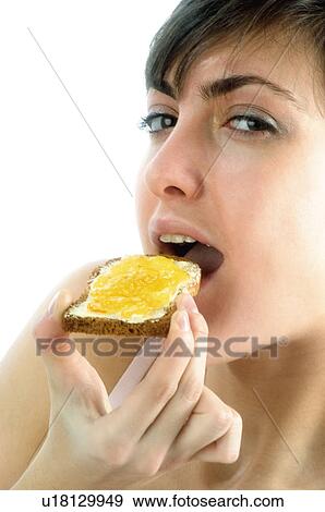 Stock Photo - Woman, Breakfast, Having breakfast, Beauty, Young, Young woman, Brown hair. Fotosearch