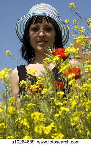Stock Photo - Woman, Young, Nature, Country, Flowers, Country of flowers, Yellow. Fotosearch