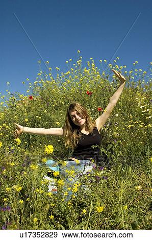 Stock Photo - Woman, Young, Nature, Country, Flowers, Country of flowers, Yellow. Fotosearch