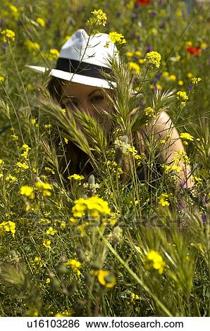Stock Photograph - Woman, Young, Nature, Country, Flowers, Country of flowers, Yellow. Fotosearch