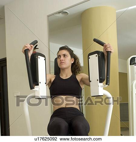Stock Image - Woman, Fitness, Gym, Gymnastics, Brown hair, Pigtail, Ponytail. Fotosearch