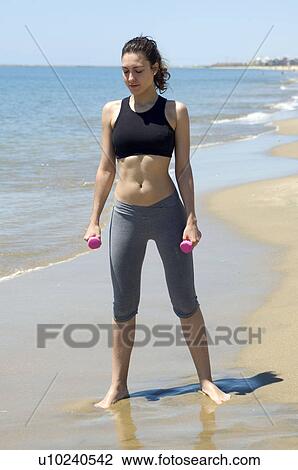 Stock Image - Woman, Fitness, Gymnastics, Brown hair, Pigtail, Ponytail, Long hair. Fotosearch