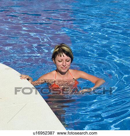Stock Photo - Woman, Beauty, Young, Face, Smiling, Brown Hair, Swimming Pool. Fotosearch