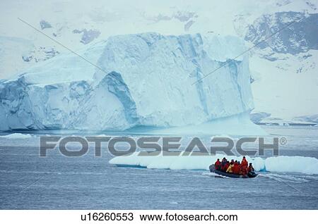 Stock Image - Boat Approaching Iceberg. Fotosearch