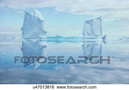 Stock Photograph - Icebergs Reflected In Water. Fotosearch