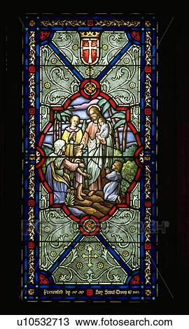 Stock Image - Jesus blessing a family on stain glass. Fotosearch