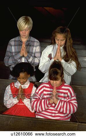 Multi-ethnic youths praying in church View Large Photo Image Stock Photograph - Multi-ethnic youths praying in church. Fotosearch