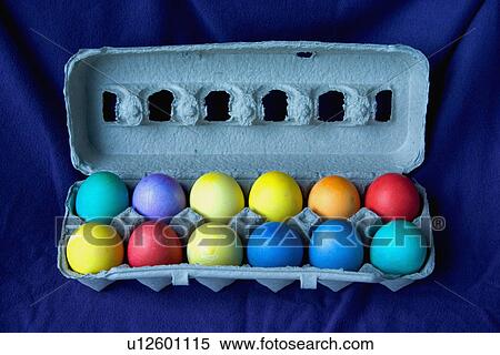 Stock Photography - A dozen dyed Easter eggs in a carton. Fotosearch
