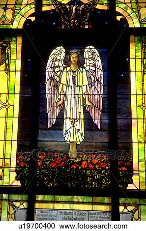 Stock Image - Angel on stained glass in church. Fotosearch