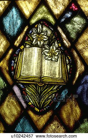 Bible and lilies on stained glass window View Large Photo Image Stock Photo - Bible and lilies on stained glass window. Fotosearch