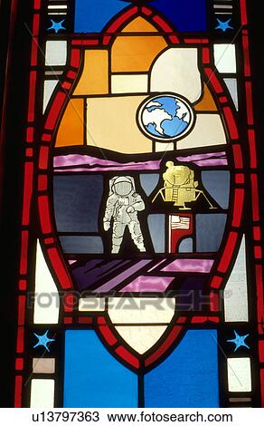 Stock Image - Neil Armstrong walking on moon stained glass window. Fotosearch
