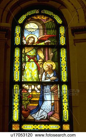 Stock Image - Stained glass window of The Annunciation in St. Pauls Cathedral. Fotosearch