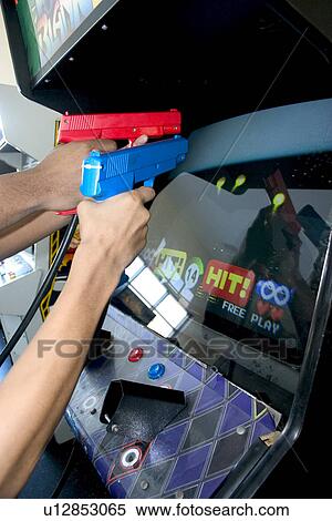 Teens shooting Point Blank video game with red and blue replica 45 caliber plastic pistols, USA View Large Photo Image Stock Photography - Teens shooting Point Blank video game with red and blue replica 45 caliber plastic pistols, USA. Fotosearch