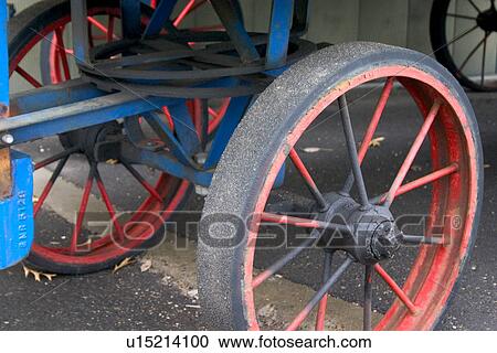 Stock Image - Spoked wheels of the railroad luggage cart at Train Station. Fotosearch