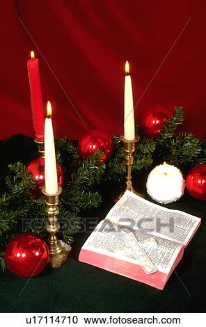 Stock Image - Bible cross candles pine boughs Christmas arrangement. Fotosearch