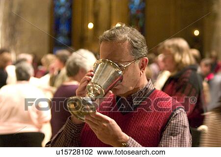 Catholic Parishioner sipping wine from chalice View Large Photo Image Stock Image - Catholic Parishioner sipping wine from chalice. Fotosearch