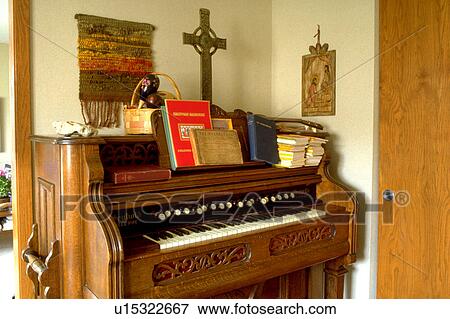 Stock Photo - Cross sitting on top of organ. Fotosearch