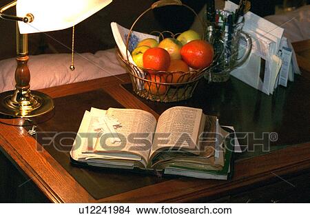 Picture - Open bible and fruit basket on desk. Fotosearch