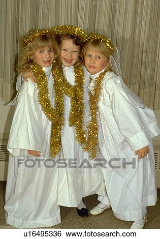 Three angels age 8 smiling at Christmas pageant View Large Photo Image Stock Photograph - Three angels age 8 smiling at Christmas pageant. Fotosearch