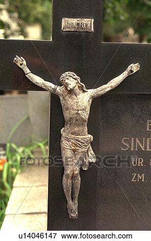 Stock Photo - Tombstone with Jesus being crucified on the cross. Fotosearch