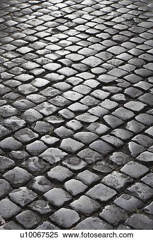Stock Photography - Close-up of cobblestone street in Rome, Italy. Fotosearch