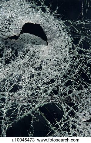 Cracked glass against black background View Large Photo Image Stock Image - Cracked glass against black background. Fotosearch