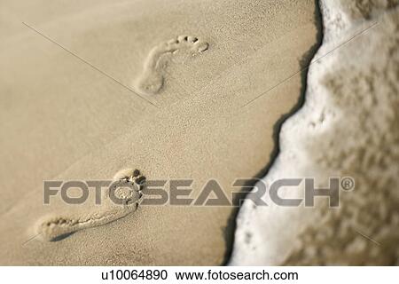 Footprints in sand next to wave. View Large Photo Image Stock Image - Footprints in sand next to wave.. Fotosearch