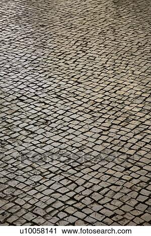 Stock Image - Stone inlayed street in Lisbon, Portugal. Fotosearch