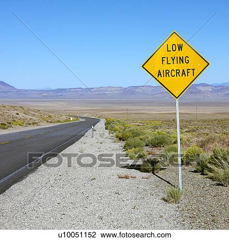 Low flying aircraft sign alongside desloate highway. View Large Photo Image Stock Image - Low flying aircraft sign alongside desloate highway.. Fotosearch