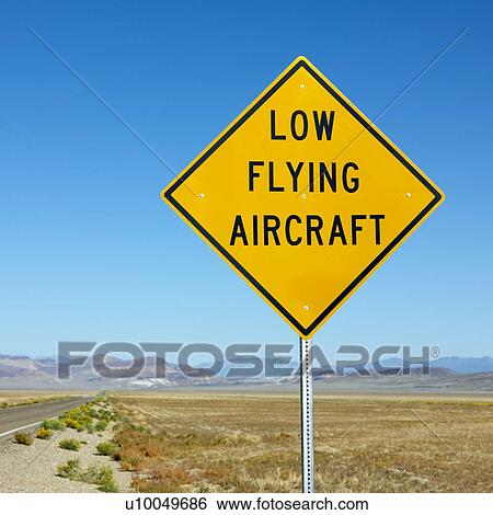 Low flying aircraft sign alongside desolate highway. View Large Photo Image Stock Photograph - Low flying aircraft sign alongside desolate highway.. Fotosearch