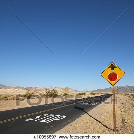Road in desert with stop sign up ahead View Large Photo Image Stock Photo - Road in desert with stop sign up ahead. Fotosearch