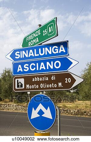 Stock Image - Road signs pointing different directions in Tuscany, Italy.. Fotosearch