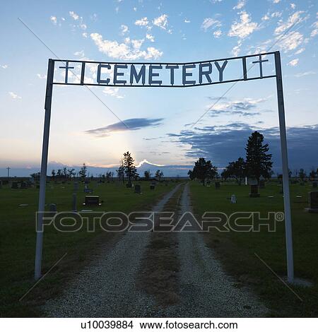 Picture - Sign over entrance to cemetary at dusk in rural South Dakota.. Fotosearch