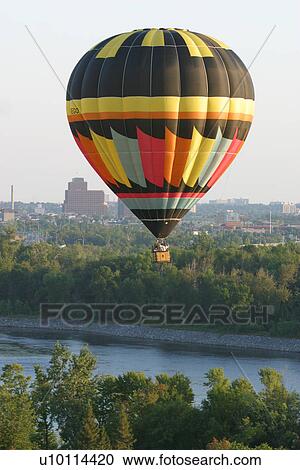 Stock Image - Gatineau Hot Air Balloon Festival, Quebec Canada with Ottawa skyline. Fotosearch
