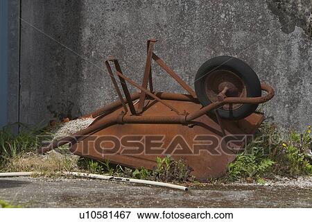 Stock Photo - carriage, unload, fallen, grass, wall, metallic. Fotosearch
