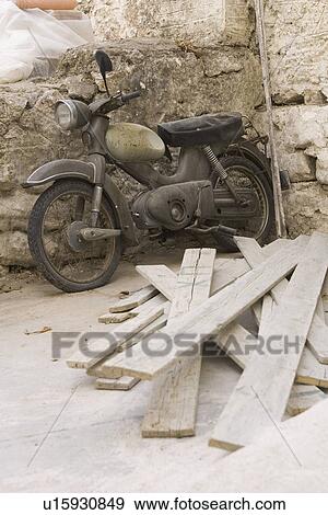 Stock Photo - Damaged, Motorcycle, Mode Of Transport, Leaning, Abandoned. Fotosearch