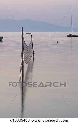 Stock Photograph - Dusk, Fishing Net, Generic Location, Horizon, Lake. Fotosearch