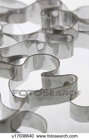 Stock Image - Shape, Shiny, Squiggle, Steel, Still Life. Fotosearch