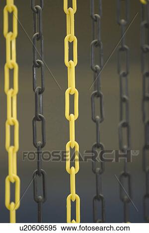 Stock Photography - yellow, bright, black, hanging, iron, barrier. Fotosearch
