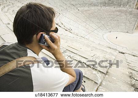 Stock Photo - Casual Clothing, T-shirt, Day, Holding. Fotosearch