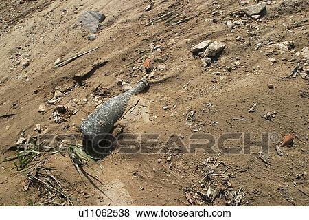 Stock Photo - dust, bottle, mud, muddy, sandy. Fotosearch