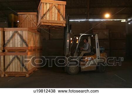 Stock Photo - worker, working, effort, factory, warehouse, carrying. Fotosearch