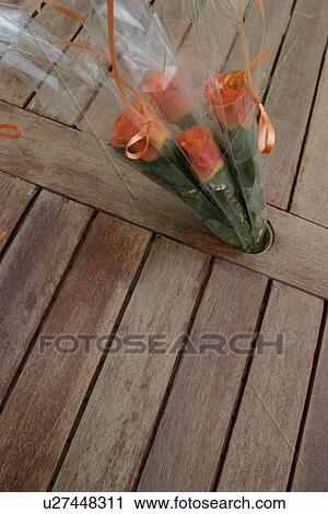 Stock Image - petals, bright, wood, wooden, floor, hole. Fotosearch