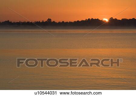 Stock Image - Dusk, Fog, Glow, Lake. Fotosearch