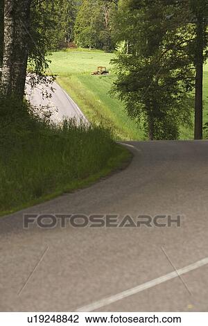 Stock Image - Country Road, Countryside, Curving, Day, Dividing Line. Fotosearch