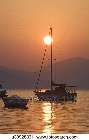 Stock Image - Boat, Dusk, Glow, Mountain, Mountain Range. Fotosearch