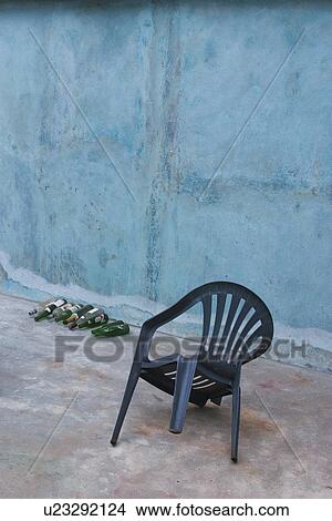 Picture - Chair, Plastic Chair, Bottles, Glass Bottles, Day. Fotosearch