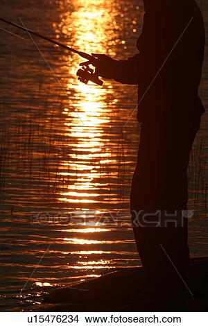 Picture - silhouette, sun, fishing reel, reel, line. Fotosearch